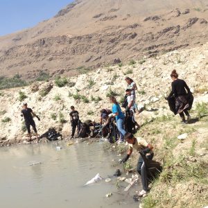 Volunteers are collecting the trash aroud the river